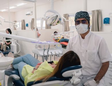 a man in a dentist's office wearing a mask