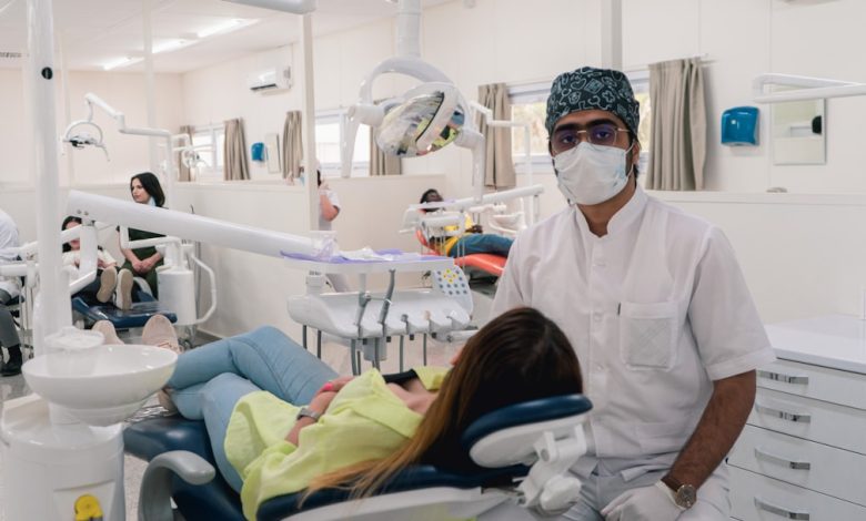 a man in a dentist's office wearing a mask