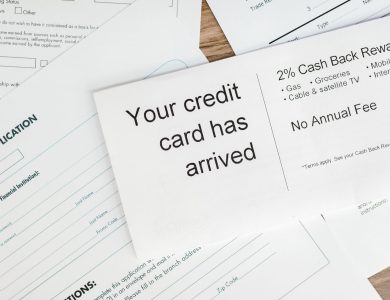 Close-up of a letter announcing the arrival of a credit card amidst financial documents.