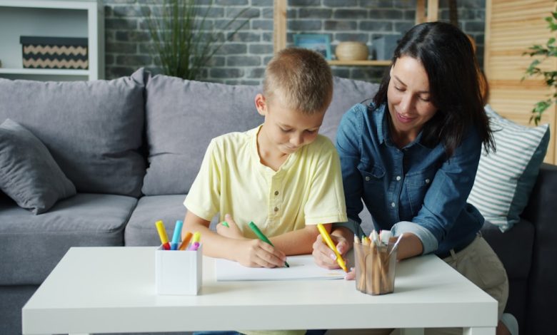 Mother and son drawing together at a table.