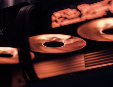 Dynamic close-up shot of illuminated gaming graphics card fans in red light, showcasing cutting-edge technology.