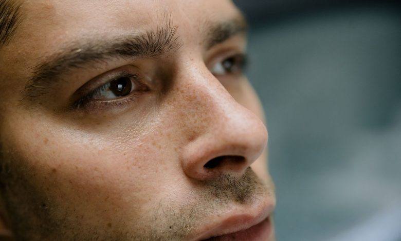 Detailed close-up portrait focusing on a man's facial features and skin texture.
