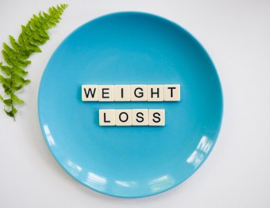 A blue plate with 'weight loss' tiles and a fern leaf on white background.