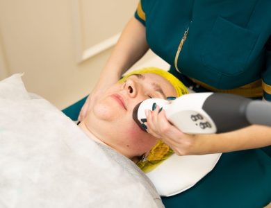 Close-up of a woman receiving a modern facial treatment in a beauty clinic.