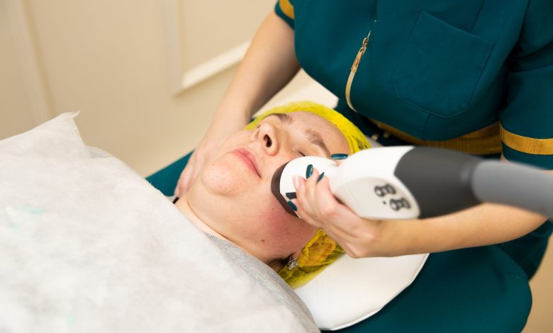 Close-up of a woman receiving a modern facial treatment in a beauty clinic.