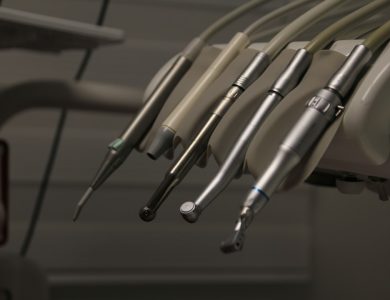 a row of dental instruments hanging from a wall