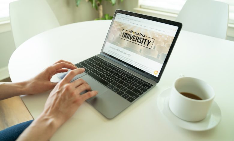 black and gray laptop beside teacup