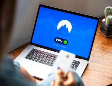 A person using a VPN on a laptop, symbolizing secure internet browsing in a modern indoor setting.