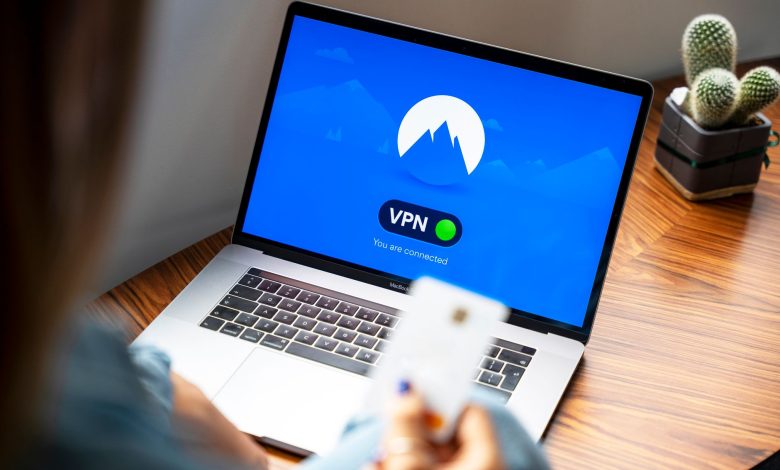 A person using a VPN on a laptop, symbolizing secure internet browsing in a modern indoor setting.