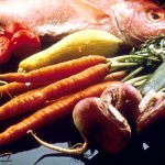A display of vegetables, grains, beans, fish, bread and other foods.