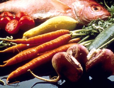 A display of vegetables, grains, beans, fish, bread and other foods.