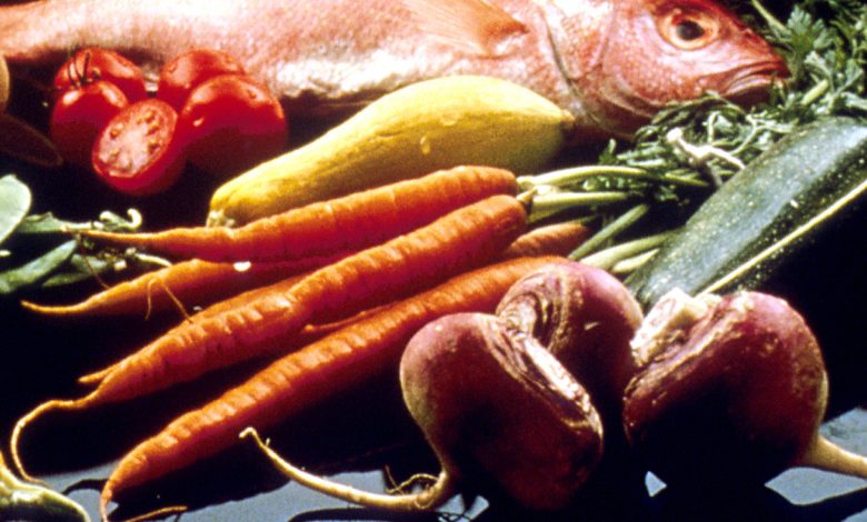 A display of vegetables, grains, beans, fish, bread and other foods.