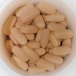 Multivitamin tablets shown together on a neutral surface.