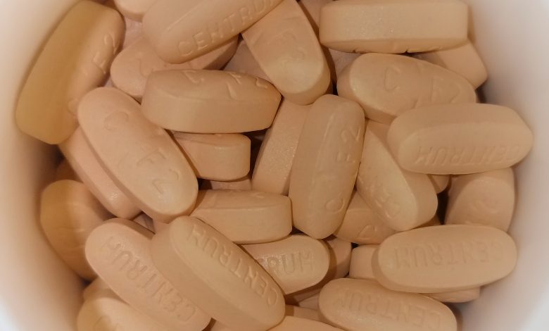 Multivitamin tablets shown together on a neutral surface.