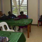 A nutrition educator speaking to a group during a community lecture.