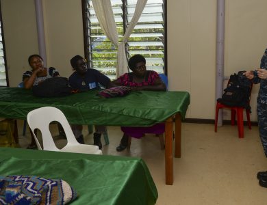 A nutrition educator speaking to a group during a community lecture.