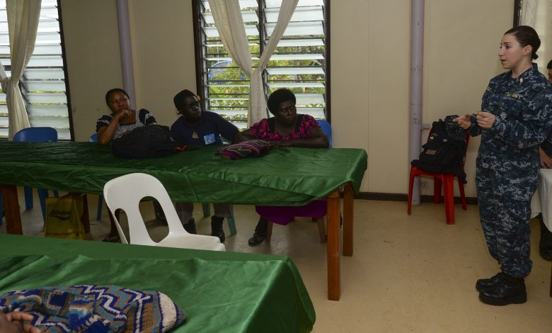 A nutrition educator speaking to a group during a community lecture.