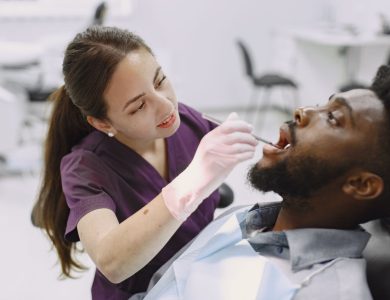 Dentist examining a patient during a dental check-up in a modern clinic. Professional care with focus on oral health.